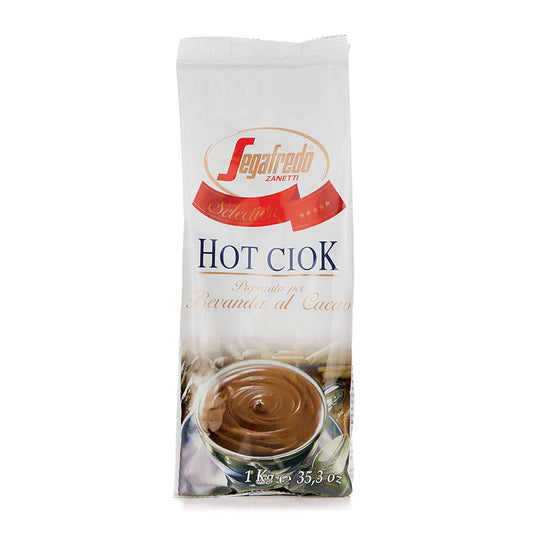 A 1 kg package of Segafredo Zanetti Hot Ciok (Hot Chocolate) mix displayed upright with a picture of a cup of prepared hot cocoa, boasting high cocoa butter content.