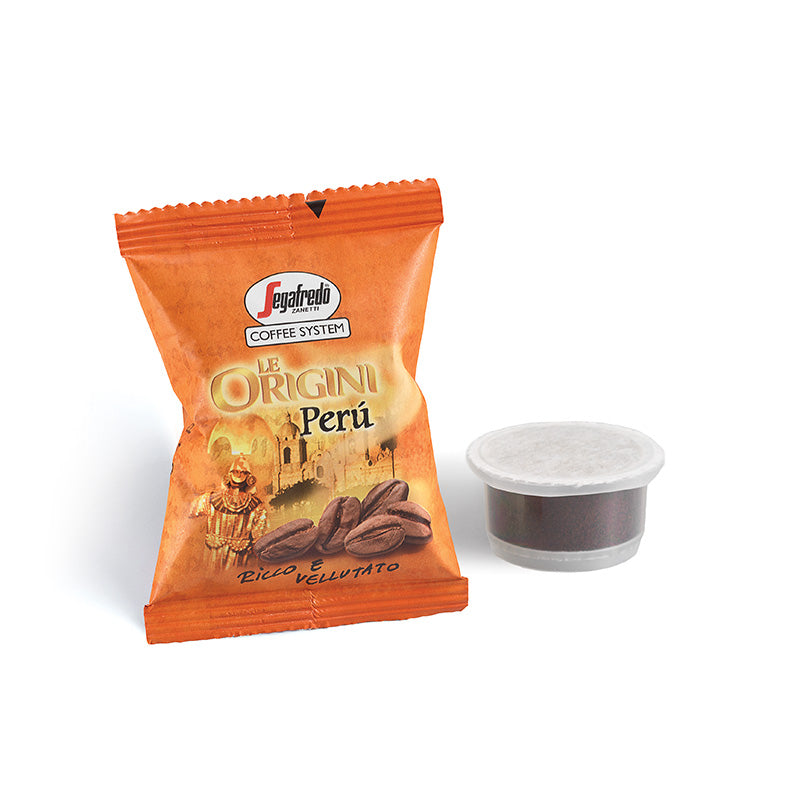 A packet of Segafredo Zanetti Segafredo Peru Single Origin Espresso Single-Serve Cartridges, featuring an image of coffee beans and a cultural scene, next to a sealed coffee pod, promises the rich chocolate tones characteristic of single origin espresso made from premium Peruvian coffee.